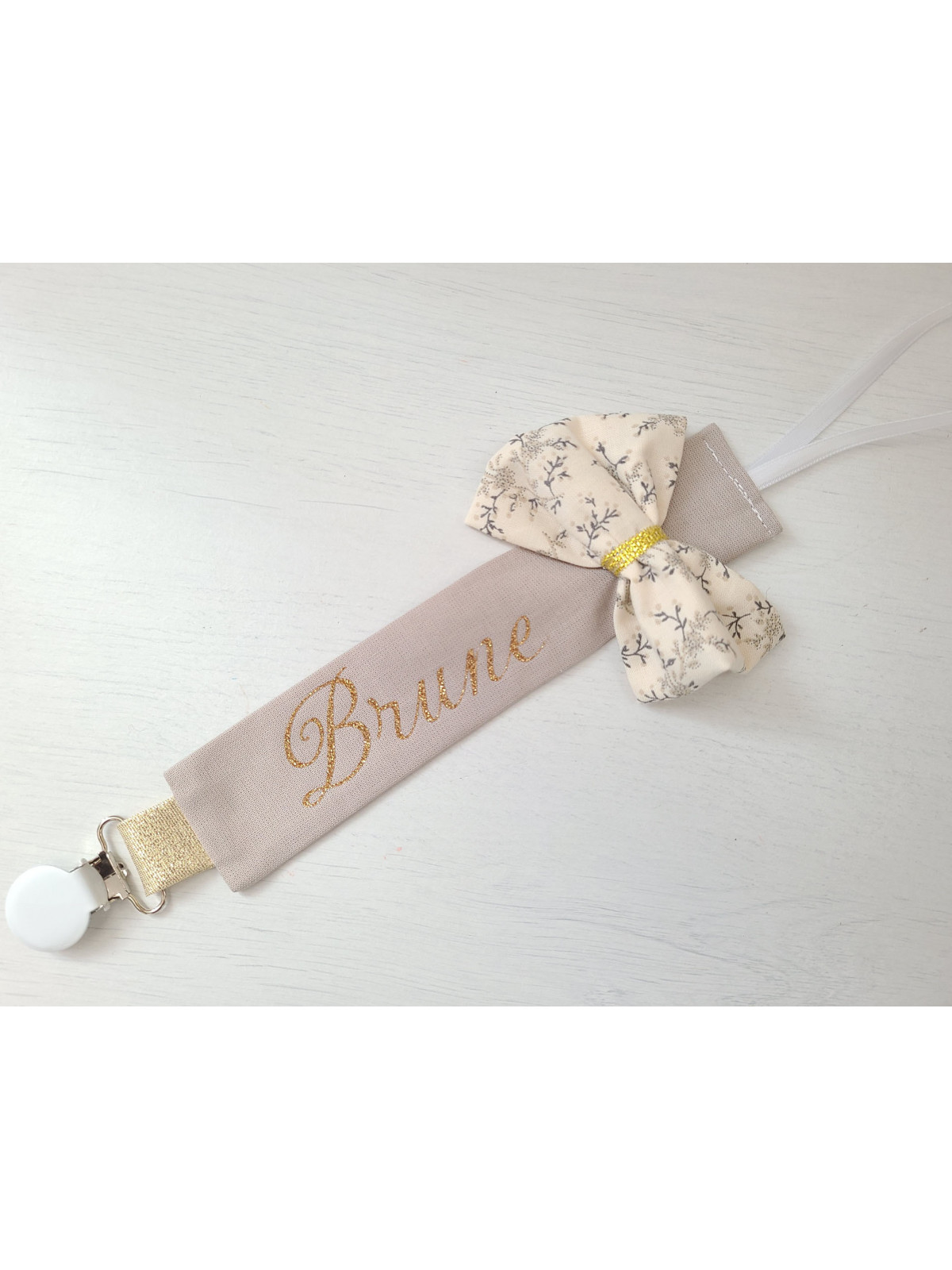 Attache tétine personnalisée beige et or, noeud fleuri